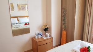 a bedroom with a bed and a mirror and a table at Apartamento Nerja Beach in Nerja