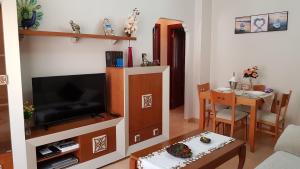 a living room with a television and a table at Apartamento Nerja Beach in Nerja