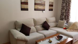 a living room with a couch and a coffee table at Apartamento Nerja Beach in Nerja