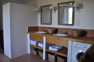 a bathroom with two sinks and a mirror at Maison vigneronne in Montlaur +28 photos