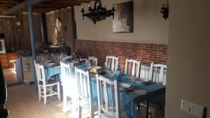 a dining room with a blue table and white chairs at Casa de la abuela Bego in Los Molinos de Ocón