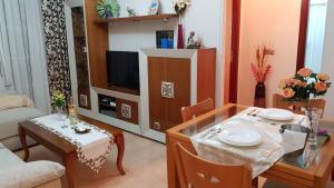 a living room with a dining table and a television at Apartamento Nerja Beach in Nerja