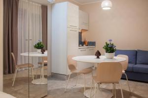 a living room with two tables and a blue couch at Le Sinfonie Rooms in Porto Cesareo +46 photos
