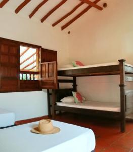 a room with three bunk beds and a hat at La Casa de Hercilia Boutique in Barichara