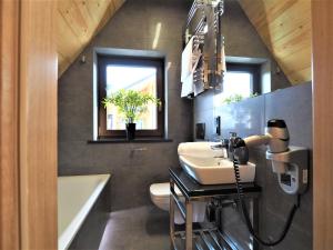 a bathroom with a sink and a bath tub at VIP APARTAMENTY VILLA GÓRSKIE KLIMATY in Zakopane +87 photos