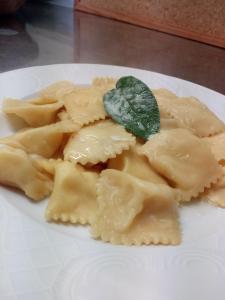 a plate of ravioli with a green leaf on it at Agriturismo Rio Ricco in Busana