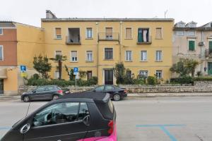 a car parked in a parking lot in front of a building at Apartment Nicol in Pula