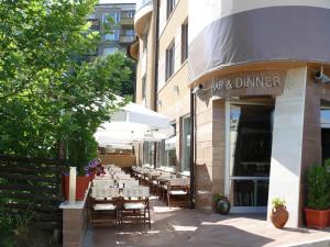 a row of tables and chairs outside of a restaurant at Elate Plaza Hotel in Sofia
