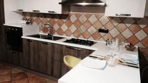 a kitchen with a stove and a white counter top at Casa Traiano in Benevento