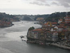 a view of a river with buildings and a bridge at Guest House Porto Clerigus in Porto