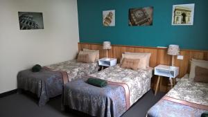 a bedroom with two beds and a desk at Moe Motor Inn - Contactless 24 hour Checkinn Available in Moe