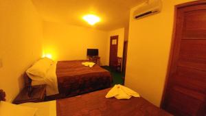 Postel nebo postele na pokoji v ubytování Hostal El Peregrino