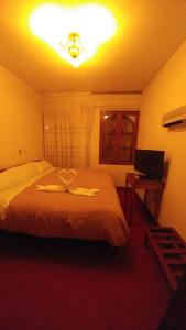 Postel nebo postele na pokoji v ubytování Hostal El Peregrino
