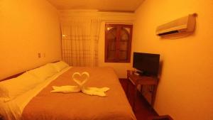 Postel nebo postele na pokoji v ubytování Hostal El Peregrino