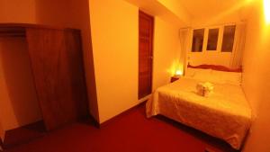 Postel nebo postele na pokoji v ubytování Hostal El Peregrino
