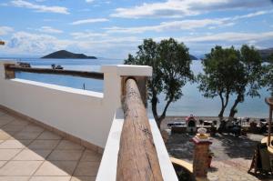 a white fence with a view of the ocean at Panteli Beach Hotel in Panteli