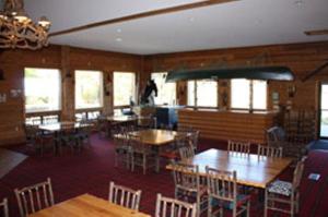 a dining room with tables and chairs and windows at The Lodge at Crooked Lake in Siren