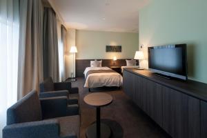TV a/nebo společenská místnost v ubytování Ginza Grand Hotel