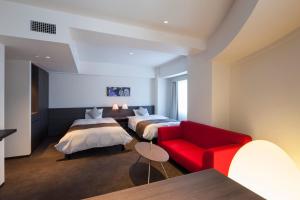 Ένα ή περισσότερα κρεβάτια σε δωμάτιο στο Ginza Grand Hotel