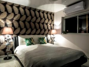 a bedroom with a large bed with two lamps at FaRoyal Luxury Suite in Eilat