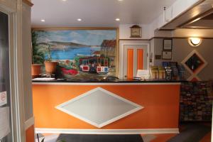 a counter in a store with a painting on the wall at Layne Hotel in San Francisco