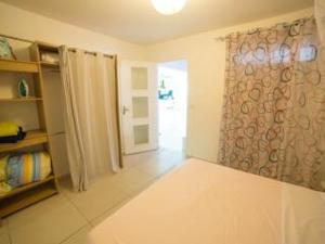 a room with a shower curtain and a room with a door at Bounaco in Le Gosier