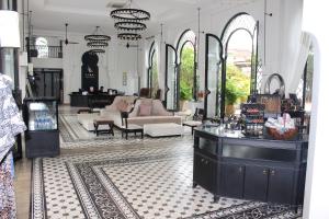 a room with a salon with a couch and a table at Sarai Resort & Spa and The Wander in Siem Reap