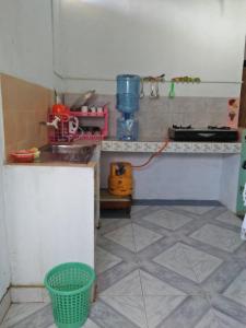 a kitchen with a sink and a counter top at Kingfisher Hostel in Anuradhapura