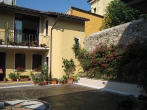a courtyard of a house with flowers and plants at A Casa da Franz in Manerba del Garda