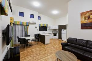 a living room with a couch and a table at BIG4 Breeze Holiday Parks - Busselton in Busselton