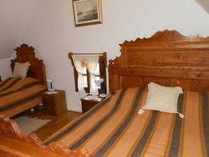 a bedroom with two beds and a mirror at Tradicije Cigoc in Čigoč