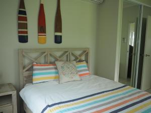 a bedroom with a bed with surfboards on the wall at Solace in South Mission Beach