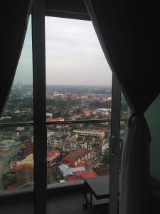 a view of a city from a large window at Julia's Cottage in Kota Bharu