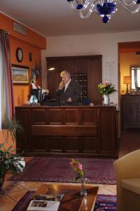 a man is standing at a podium in a room at Hotel Naonis in Cordenons