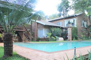 a house with a swimming pool in front of a house at 513 on Mulberry in Pretoria
