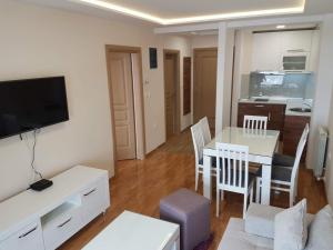 a living room with a table and a dining room at Apartment Kristal in Zlatibor