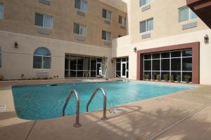 a swimming pool in front of a building at Garden Place Suites in Sierra Vista