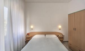Postel nebo postele na pokoji v ubytování Hotel Cecile