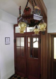 a room with a wooden door with a chandelier above it at Hotel B&B Steinasäge in Bonndorf im Schwarzwald