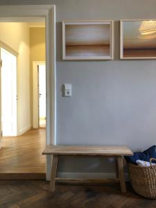 a room with a bench against a blue wall at Kaiser Ludwig´s wundervolle Ferienwohnung in Munich