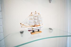 a small wooden boat on a glass table at Hotel Argo in Arkhangelsk