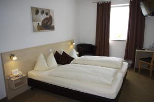 Postel nebo postele na pokoji v ubytování Hotel - Gasthof Erber