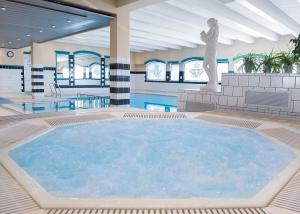 a large swimming pool with a statue in a building at Fleischer's Motel in Vossevangen