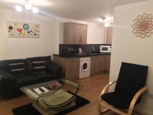 a living room with a couch and a table at Eastgate Apartment in Inverness