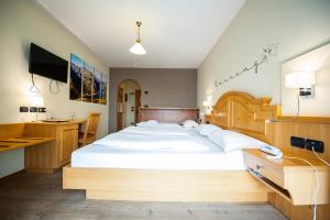 Postel nebo postele na pokoji v ubytování Hotel Touring