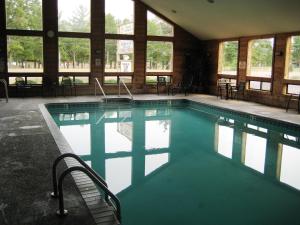 a large swimming pool in a building with windows at The Lodge at Crooked Lake in Siren