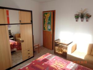 1 dormitorio con cama, armario y espejo en les lilas en Ammerschwihr