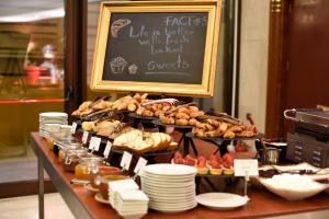 a buffet of food on a table with a chalkboard at Grand Hotel Bucharest in Bucharest
