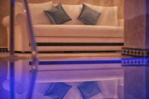 a couch with two pillows on it in a room at Lina Ryad & Spa in Chefchaouene