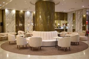 a lobby with a table and chairs and a fountain at Grand Hotel Bucharest in Bucharest